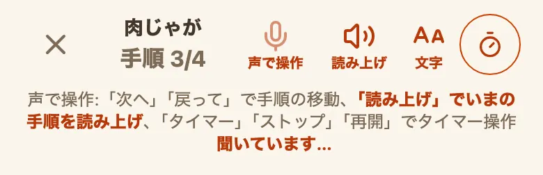 調理中モードの上部。左に✕、中央に「肉じゃが」と「手順 3/4」、右に「声で操作」「読み上げ」「文字」のボタンと丸で囲んだタイマーのマークが1列に並んでいる。その下に声で使える言葉の案内が続けて表示され、真ん中の「「読み上げ」でいまの手順を読み上げ」だけ色を変えた太字になっており、最後に「聞いています…」と表示されている